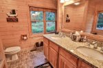 Large ensuite bathroom off main floor master with dual sinks, walk-in shower and soaking tub.